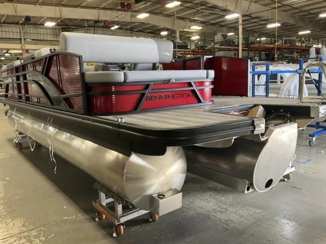 Slide: The Image of 2025 Bennington 23 SSB pontoon boat in a factory setting. - 8
