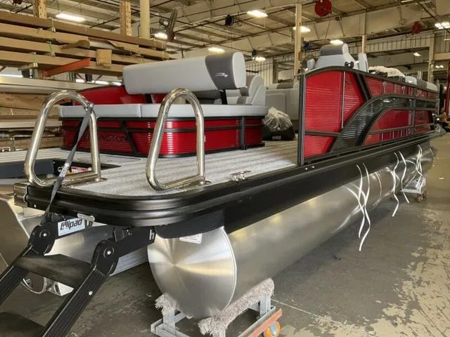 Slide: The Image of 2025 Bennington 23 SSB pontoon boat in a warehouse setting. - 9