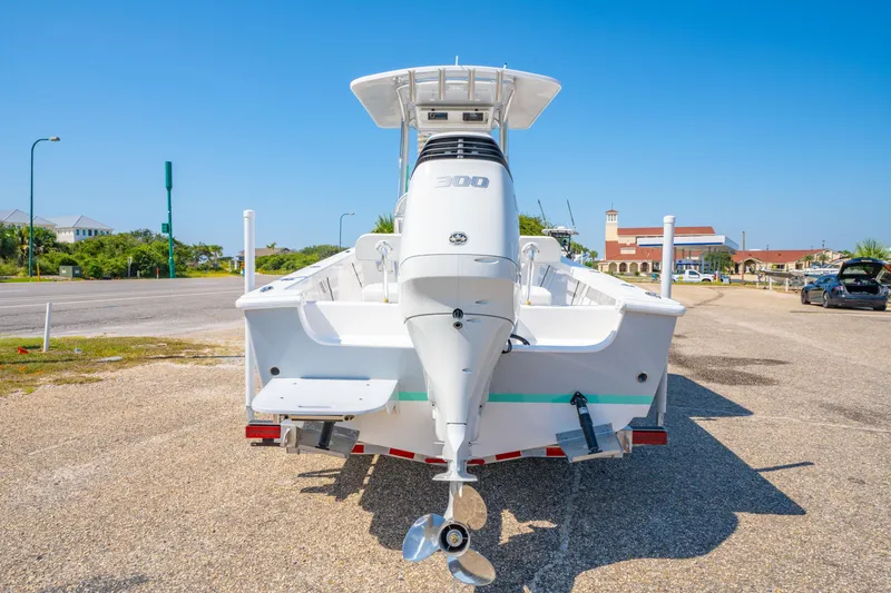 Slide: The Image of 2026 Albury Brothers 23 boat with powerful outboard motor, parked on sunny day. - 10