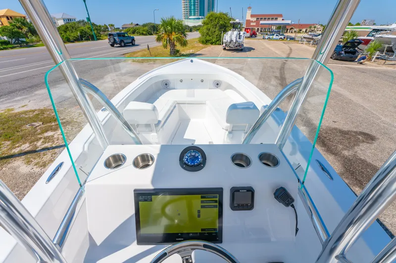 Slide: The Image of 2026 Albury Brothers 23 boat dashboard with navigation equipment and cup holders. - 11