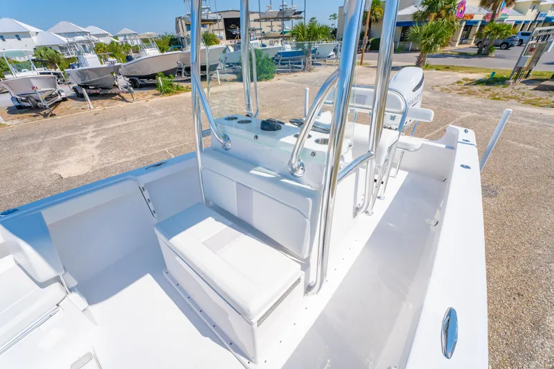 Slide: The Image of 2026 Albury Brothers 23 boat interior with seating and console, parked outdoors. - 18