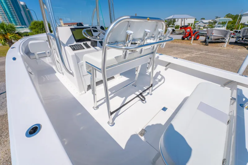 Slide: The Image of 2026 Albury Brothers 23 boat interior with helm and seating, docked outdoors. - 21