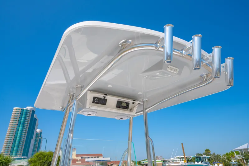 Slide: The Image of 2026 Albury Brothers 23 boat with T-top and rod holders against clear blue sky. - 22