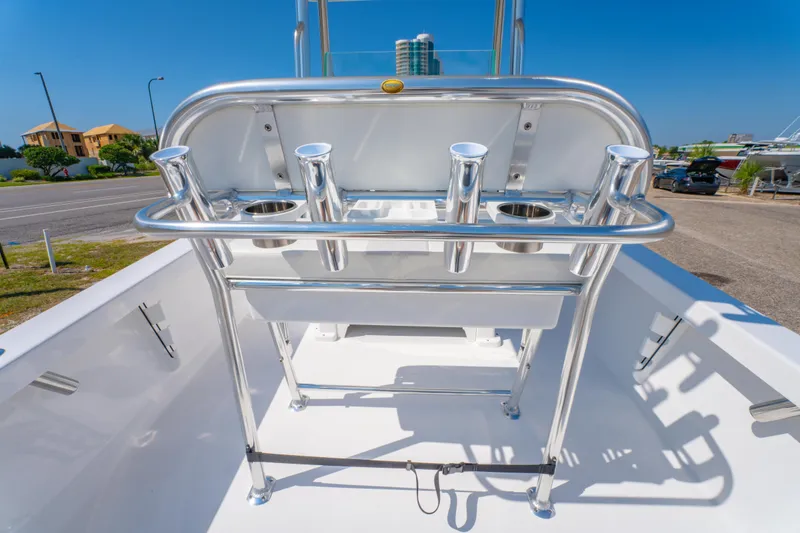 Slide: The Image of 2026 Albury Brothers 23 boat with stainless steel rod holders and seating, docked under clear blue sky. - 23