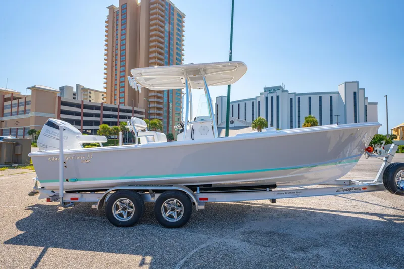 Slide: The Image of 2026 Albury Brothers 23 boat on trailer, urban backdrop, sunny day. - 5