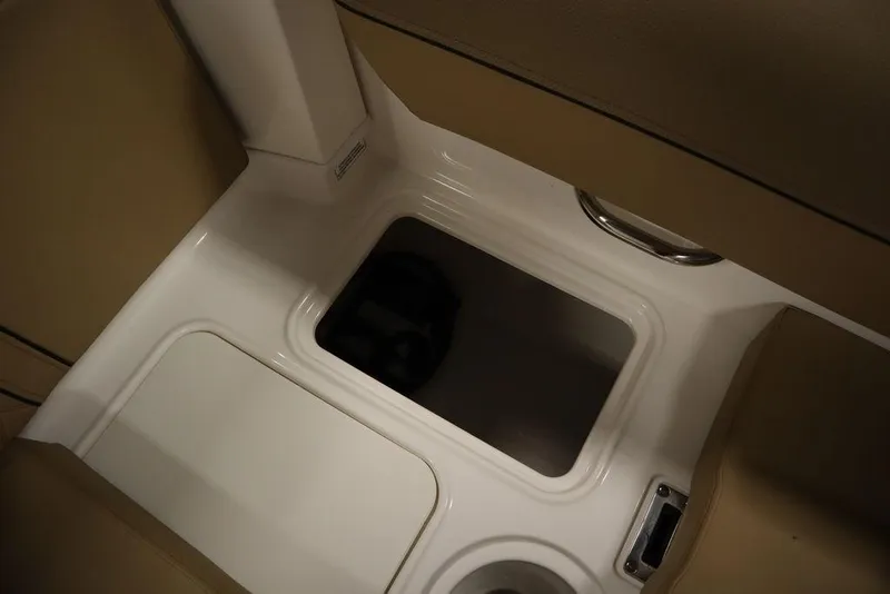 Slide: The Image of 2024 Bayliner DX2050 boat storage compartment with beige interior. - 12