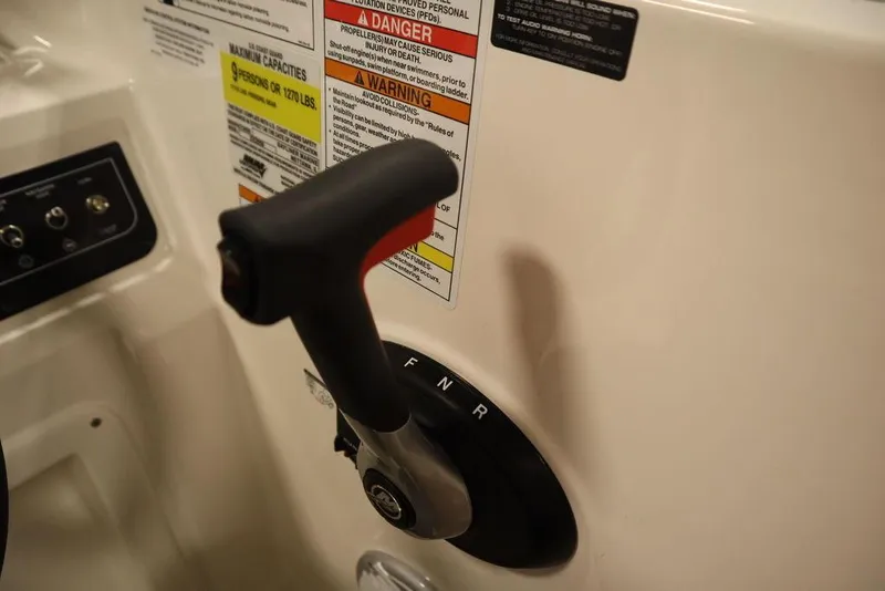 Slide: The Image of 2024 Bayliner DX2050 boat throttle control with safety warnings. - 16