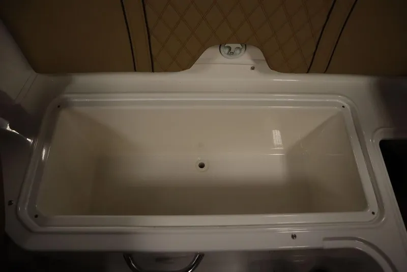 Slide: The Image of 2024 Bayliner DX2050 boat storage compartment, white interior, spacious design. - 17