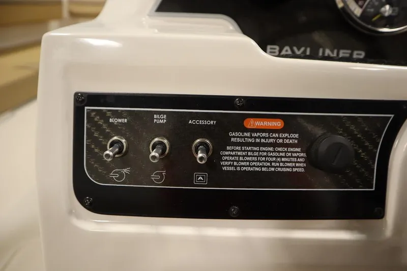 Slide: The Image of Control panel of 2024 Bayliner DX2050 boat with switches and safety warning. - 24