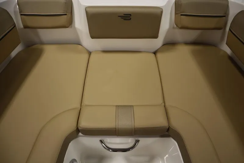 Slide: The Image of 2024 Bayliner DX2050 boat interior with tan cushioned seating. - 25