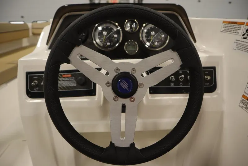Slide: The Image of 2024 Bayliner DX2050 steering wheel and dashboard close-up. - 26