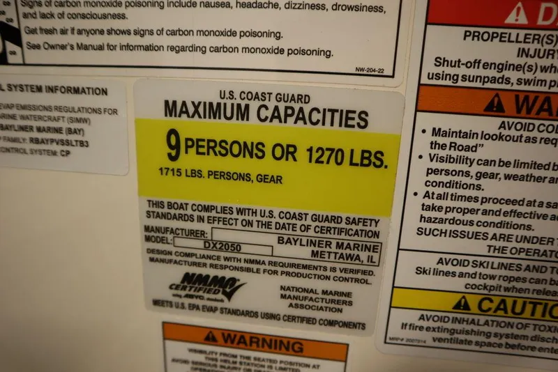 Slide: The Image of Bayliner DX2050 2024 boat capacity label: 9 persons or 1270 lbs. - 28