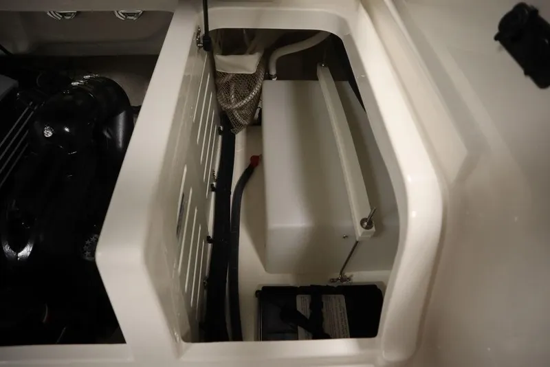 Slide: The Image of 2024 Bayliner DX2050 engine compartment with storage and components. - 31