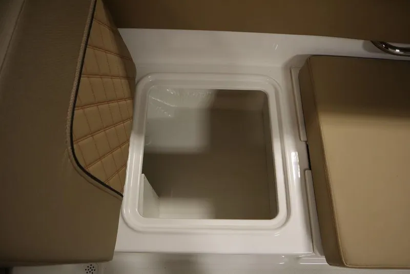 Slide: The Image of 2024 Bayliner DX2050 boat storage compartment with cushioned seating. - 33