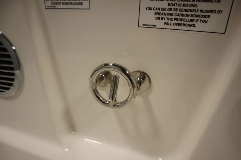 Slide: The Image of 2024 Bayliner DX2050 boat interior detail with chrome handle and safety warnings. - 41