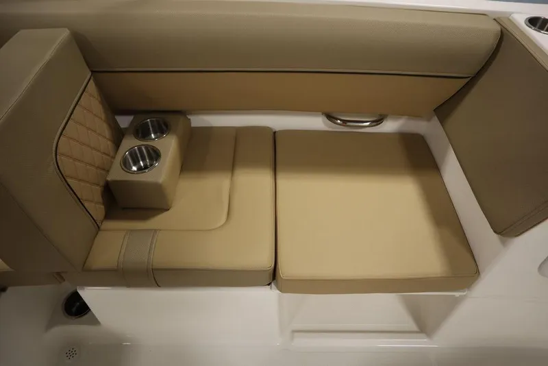 Slide: The Image of 2024 Bayliner DX2050 boat interior with tan seating and cup holders. - 46