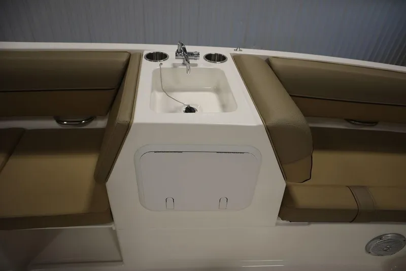 Slide: The Image of 2024 Bayliner DX2050 boat interior with seating and sink area. - 48