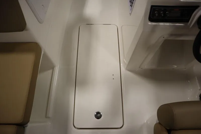 Slide: The Image of 2024 Bayliner DX2050 boat interior with storage compartment and seating. - 49