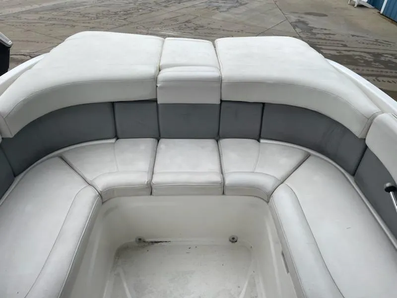 Slide: The Image of 2011 Bayliner 235 Bowrider boat interior with white and gray cushioned seating. - 10