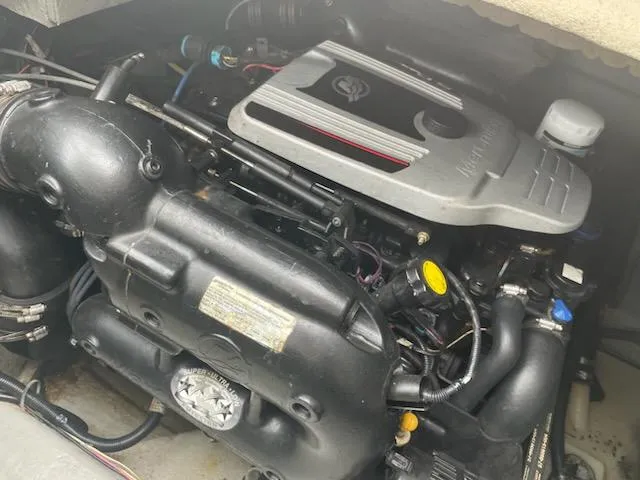 Slide: The Image of Engine of a 2011 Bayliner 235 Bowrider boat, showcasing detailed components. - 12