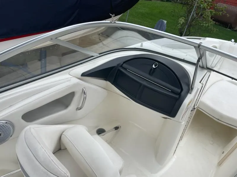 Slide: The Image of 2011 Bayliner 235 Bowrider interior with seating and dashboard view. - 13