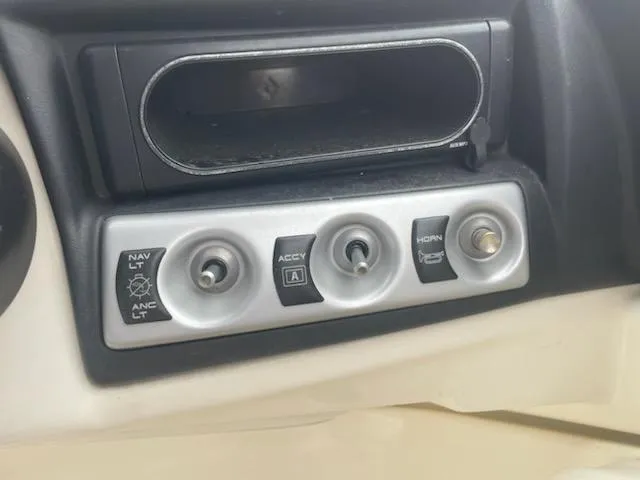 Slide: The Image of Control panel of 2011 Bayliner 235 Bowrider with switches for navigation, accessories, and horn. - 17