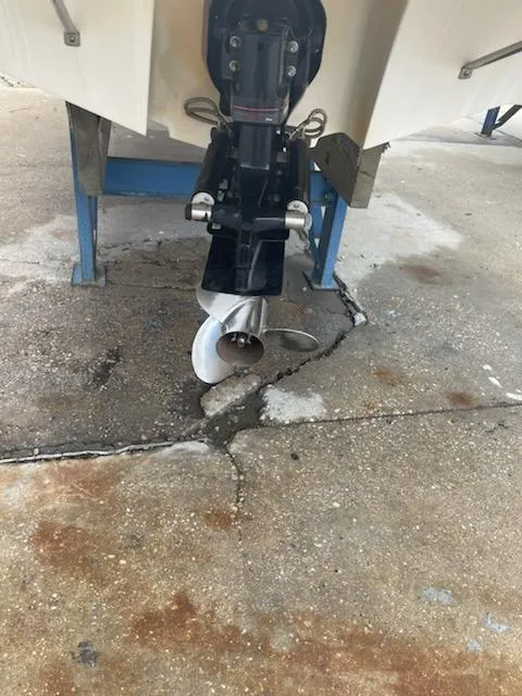 Slide: The Image of 2011 Bayliner 235 Bowrider boat propeller and stern drive on a concrete surface. - 23