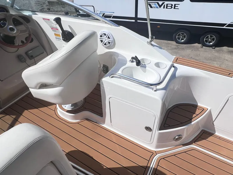 Slide: The Image of 2001 Sea Ray 260 Sundancer boat interior with helm seat and sink. - 12