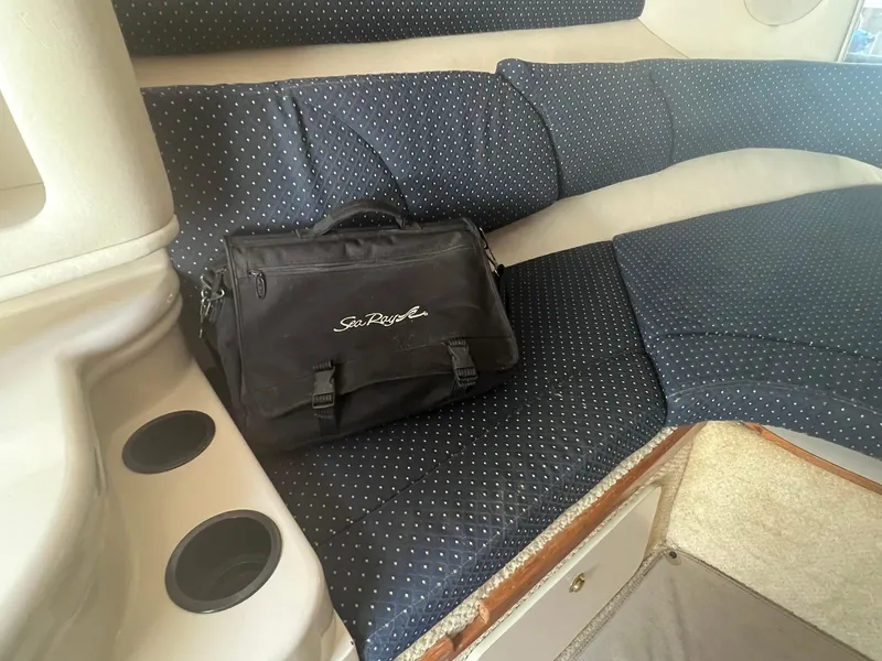 Slide: The Image of Interior of 2001 Sea Ray 260 Sundancer with a black Sea Ray bag on the seat. - 19