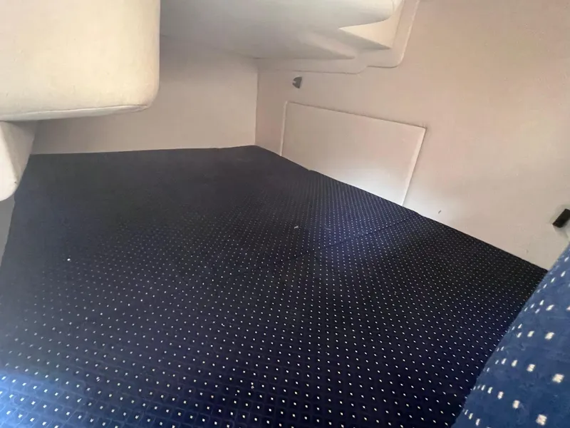 Slide: The Image of Interior cabin of 2001 Sea Ray 260 Sundancer with dark carpet and white walls. - 21