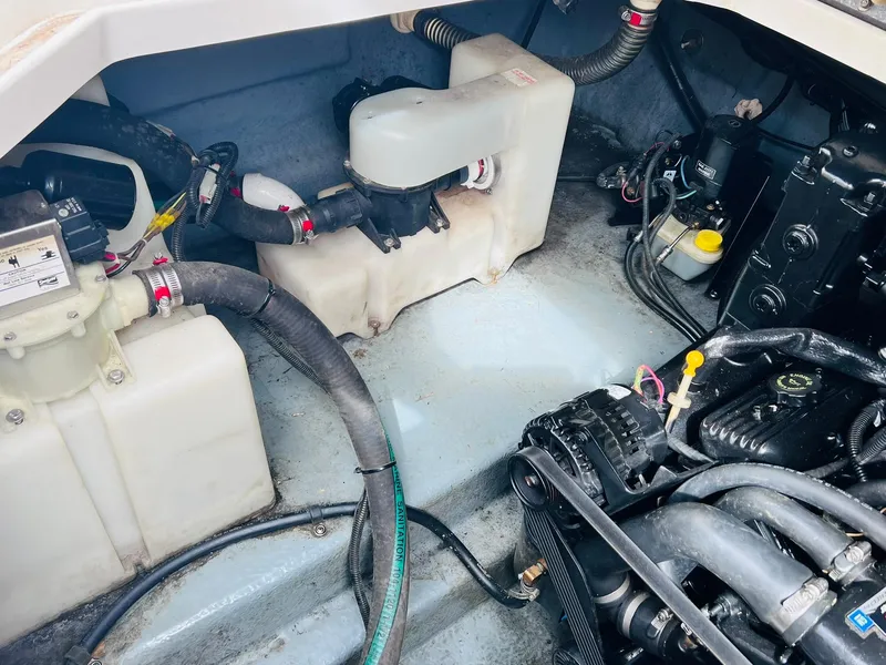Slide: The Image of Engine compartment of a 2001 Sea Ray 260 Sundancer boat, showing various mechanical components. - 32