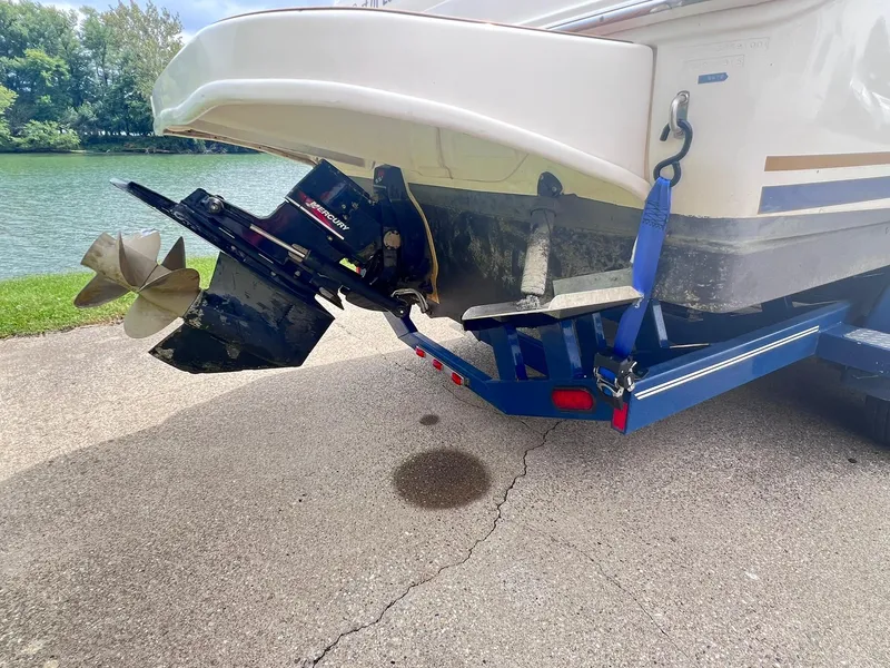 Slide: The Image of 2001 Sea Ray 260 Sundancer boat on trailer, showing propeller and stern drive. - 34