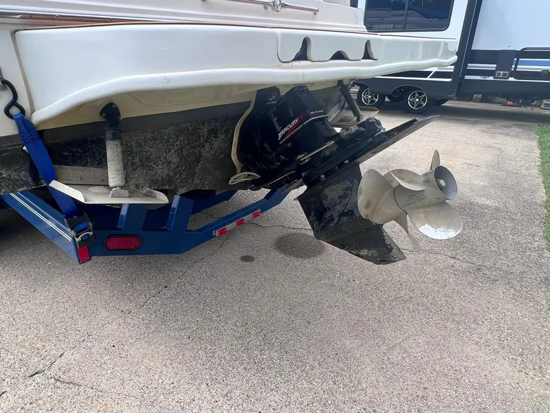 Slide: The Image of 2001 Sea Ray 260 Sundancer boat on trailer, showing propeller and stern drive. - 35