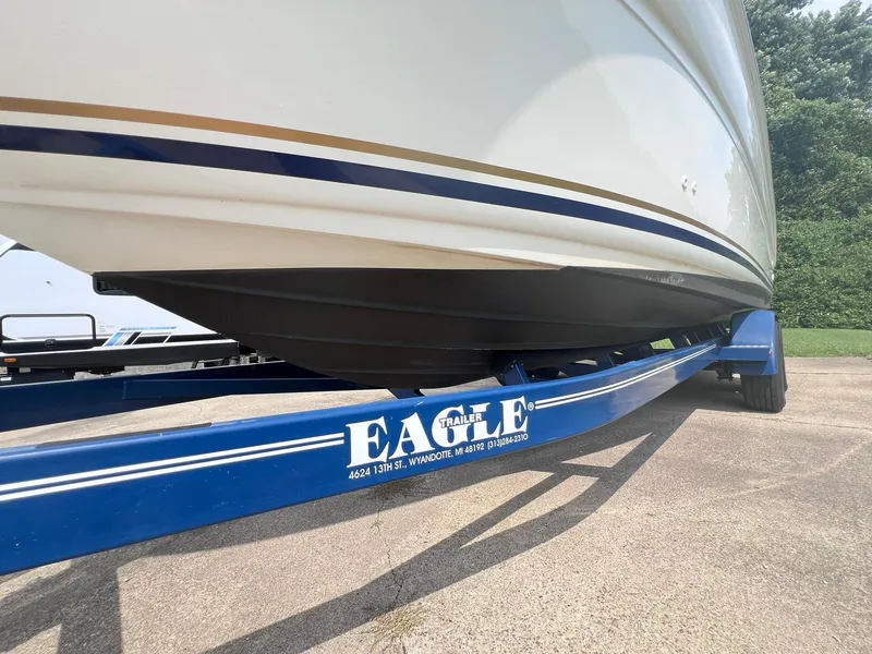 Slide: The Image of 2001 Sea Ray 260 Sundancer on blue Eagle trailer, parked outdoors. - 4