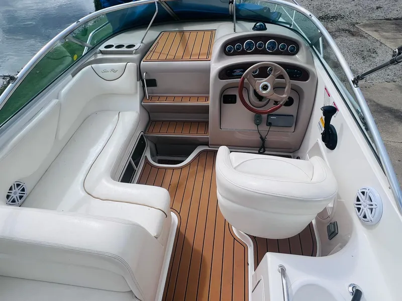 Slide: The Image of 2001 Sea Ray 260 Sundancer boat interior with white seating and wood accents. - 7