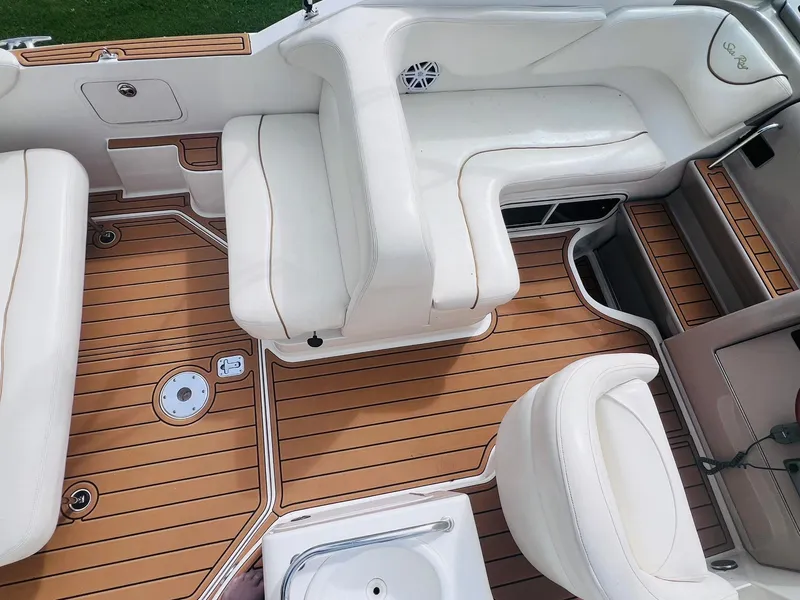 Slide: The Image of 2001 Sea Ray 260 Sundancer interior with white seating and teak flooring. - 8
