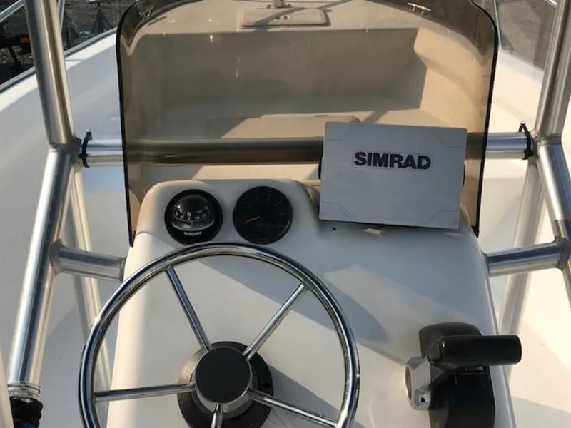 Slide: The Image of 2005 Palm Beach 1801 CC boat console with steering wheel and Simrad navigation system. - 12