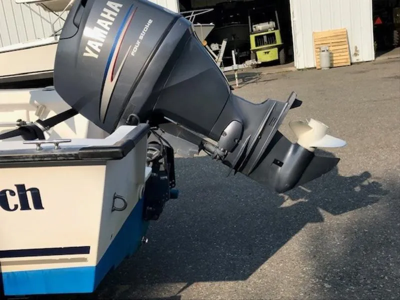 Slide: The Image of 2005 Palm Beach 1801 CC boat with Yamaha outboard motor in a marina setting. - 3