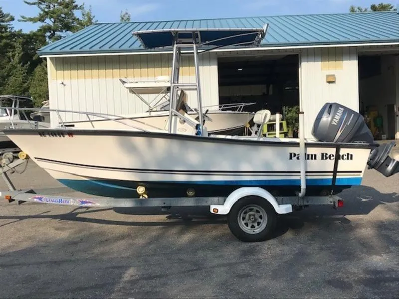 Slide: The Image of 2005 Palm Beach 1801 CC boat on trailer, parked outside a garage. - 6