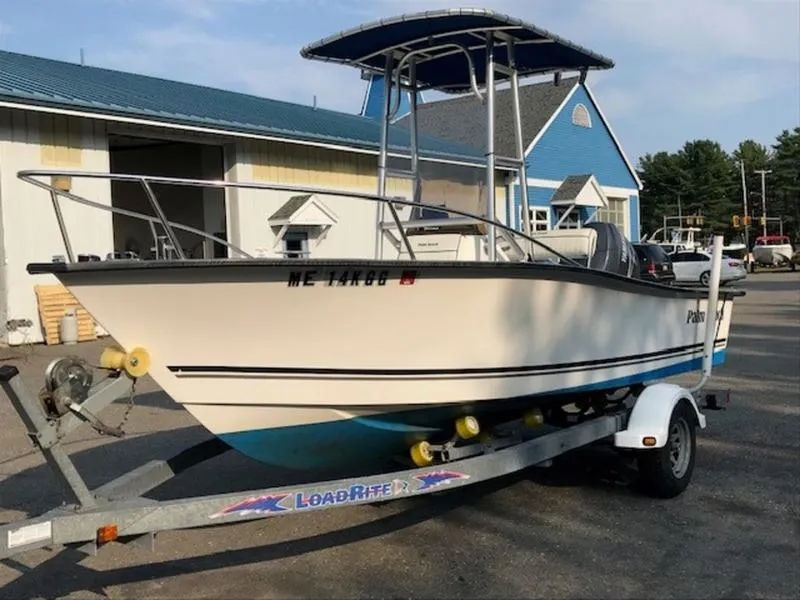 Slide: The Image of 2005 Palm Beach 1801 CC boat on trailer, parked outside a building. - 8