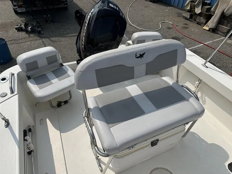 Slide: The Image of 2019 Mako 180 CC boat interior with gray and white seating. - 14