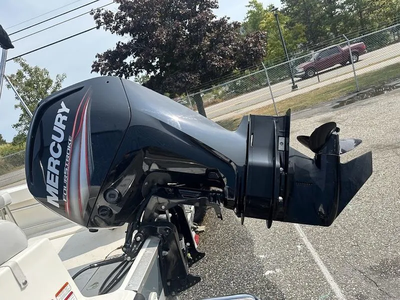 Slide: The Image of Mercury outboard motor on 2019 Mako 180 CC boat, parked outdoors. - 15