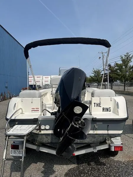 Slide: The Image of 2019 Mako 180 CC boat with outboard motor, parked outdoors. - 5