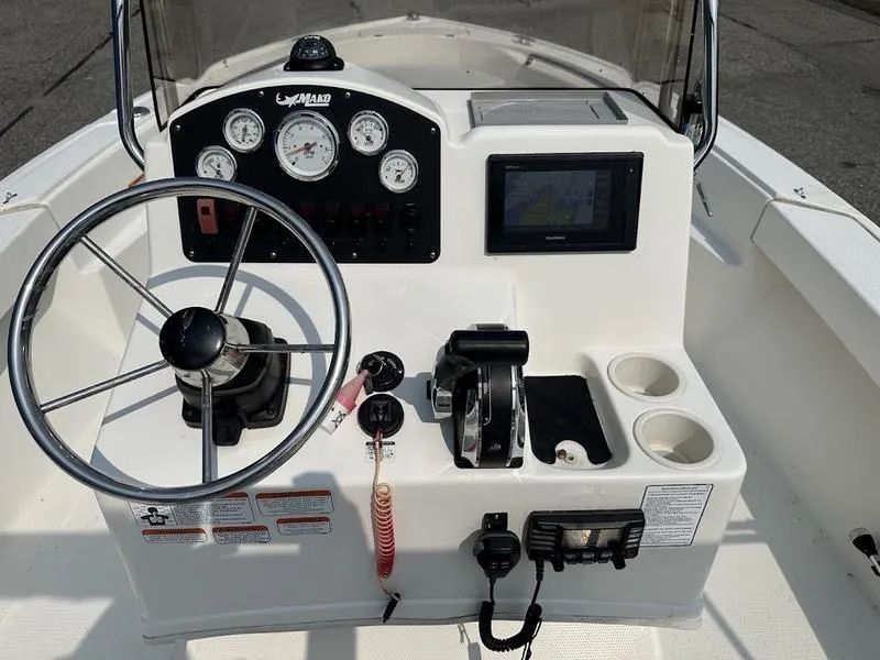 Slide: The Image of 2019 Mako 180 CC boat console with steering wheel, gauges, and controls. - 7