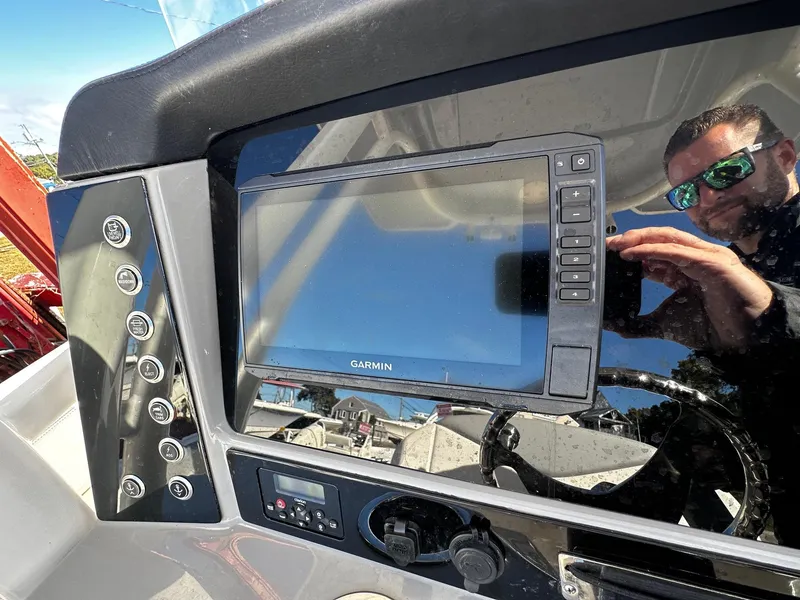 Slide: The Image of 2021 Robalo R242 Center Console dashboard with Garmin navigation system. - 10
