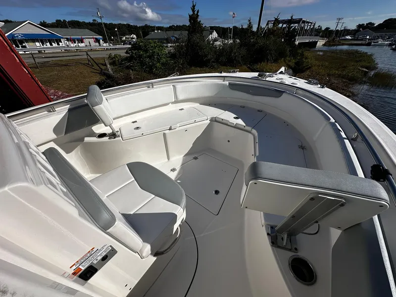 Slide: The Image of 2021 Robalo R242 Center Console boat interior with seating and storage. - 11