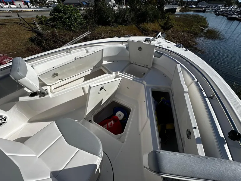 Slide: The Image of 2021 Robalo R242 Center Console boat interior with open storage compartments. - 12