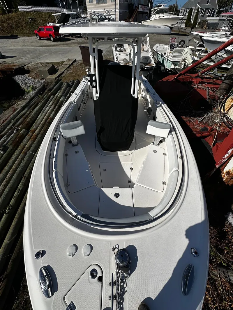 Slide: The Image of 2021 Robalo R242 Center Console boat, white exterior, docked outdoors. - 17