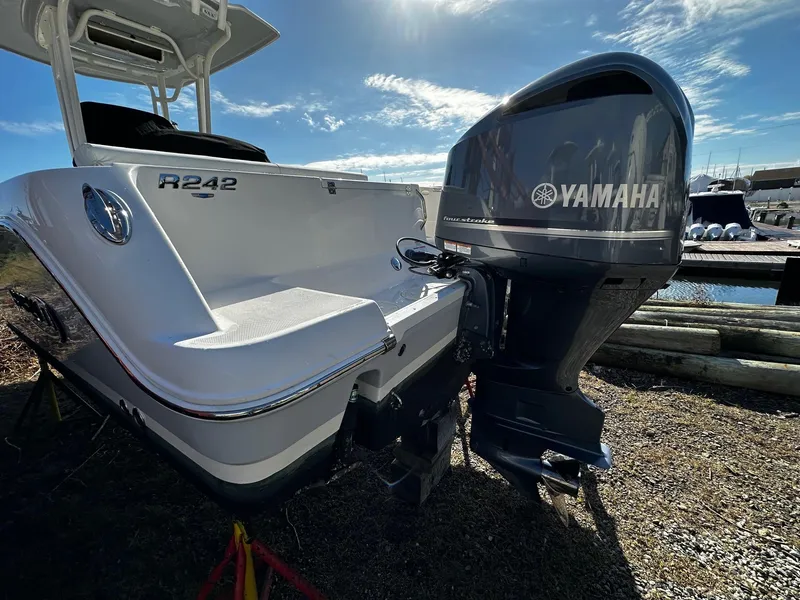 Slide: The Image of 2021 Robalo R242 Center Console boat with Yamaha outboard motor, docked under sunny skies. - 19