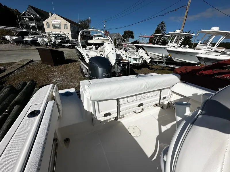 Slide: The Image of 2021 Robalo R242 Center Console boat in a marina with other vessels. - 3